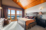 Experience luxury in this stunning bedroom with breathtaking mountain views.