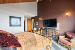 This luxurious bedroom boasts a stunning design with a warm and inviting ambiance.