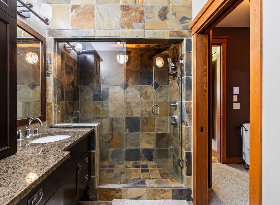 Step into luxury with this stunning bathroom featuring a walk-in shower with beautiful tile work.