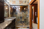 Step into luxury with this stunning bathroom featuring a walk-in shower with beautiful tile work.