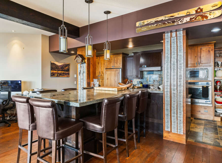 This stunning kitchen boasts a spacious island with seating, perfect for entertaining or casual dining.