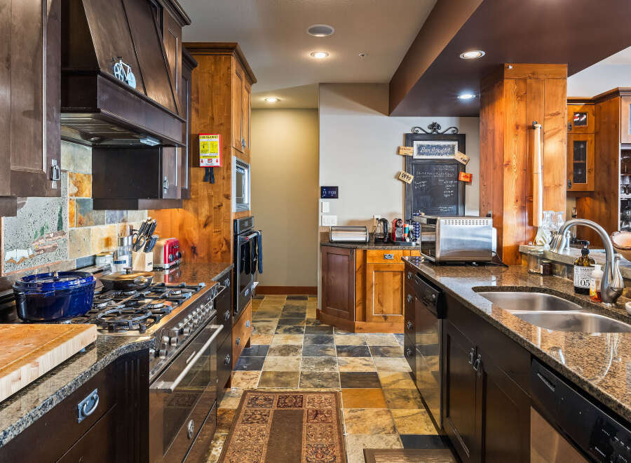 This stunning kitchen boasts a warm and inviting atmosphere, perfect for culinary enthusiasts.