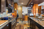 This stunning kitchen boasts a warm and inviting atmosphere, perfect for culinary enthusiasts.