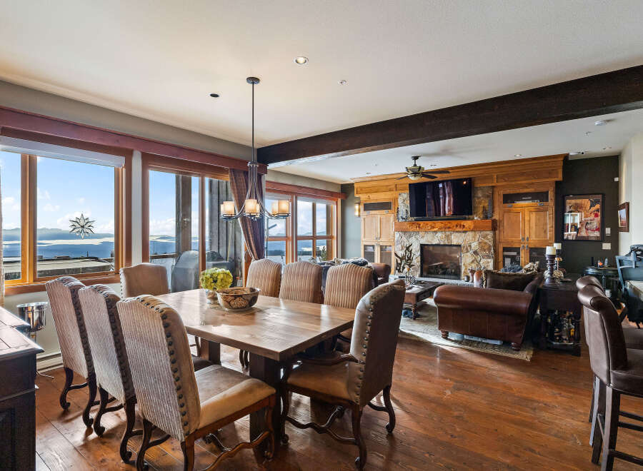 Experience luxury living in this stunning property featuring a spacious dining area with a large wooden table and comfortable seating.