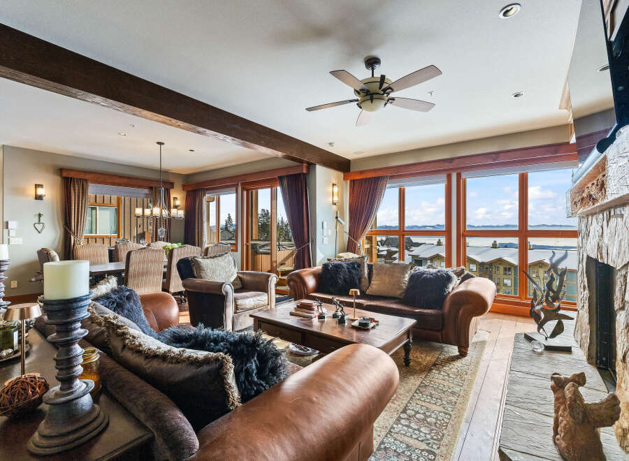 Experience luxury living in this stunning property, featuring a spacious living room with a cozy fireplace and breathtaking views.
