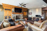 This stunning living room boasts a cozy fireplace with a stone facade, perfect for those chilly evenings.