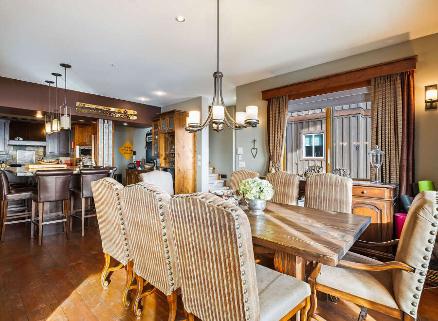 This stunning dining room showcases a rustic wooden table, perfect for family gatherings.
