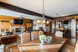 This stunning property boasts a spacious living area with a cozy fireplace and a large dining table, perfect for entertaining.