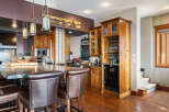 This stunning kitchen boasts a luxurious granite countertop island with comfortable bar stools, perfect for entertaining.