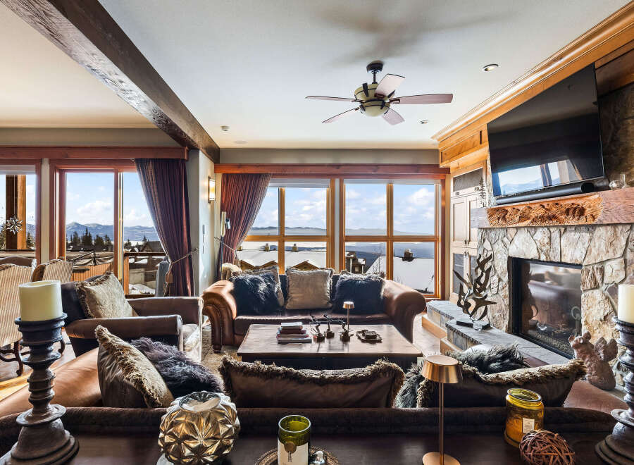 Experience luxury living in this stunning property featuring a cozy living room with a fireplace and comfortable seating.
