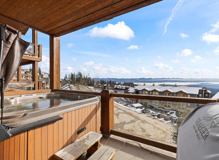 Enjoy breathtaking views from this luxurious property featuring a private hot tub and a Traeger wood-fired grill.