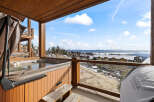 Enjoy breathtaking views from this luxurious property featuring a private hot tub and a Traeger wood-fired grill.