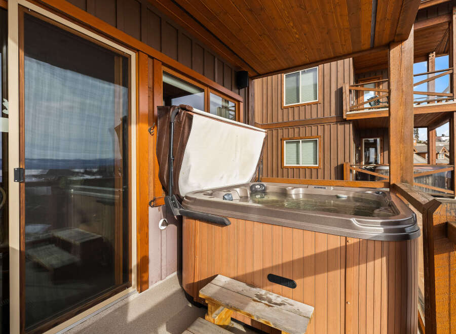 Enjoy luxurious relaxation in this stunning property featuring a private hot tub on the deck.