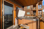 Enjoy luxurious relaxation in this stunning property featuring a private hot tub on the deck.