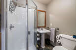 Step into this beautifully designed bathroom, featuring a modern shower and a stylish pedestal sink.