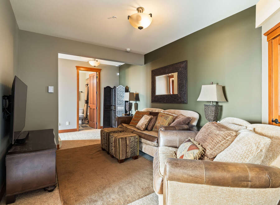 This inviting living space features a comfortable sofa and armchair, perfect for relaxing.