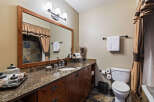 This stunning bathroom boasts a luxurious vanity with a granite countertop and ample storage.