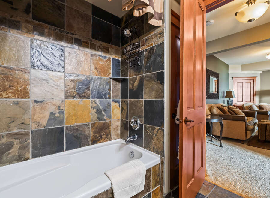 Step into luxury with this stunning bathroom featuring a beautiful tile surround and a relaxing soaking tub.