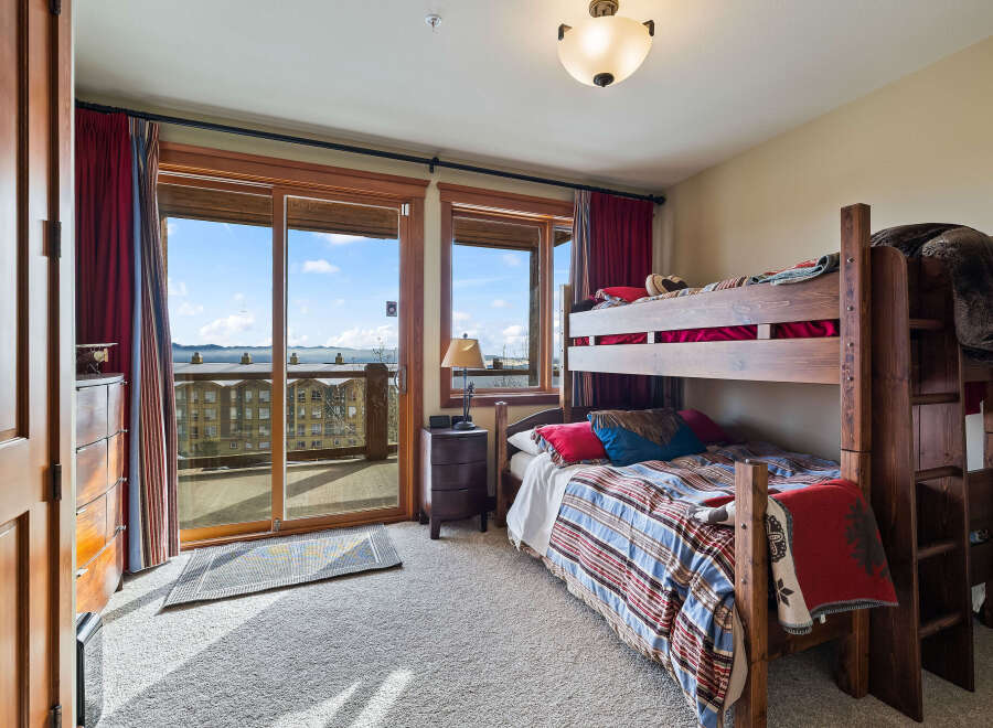 This cozy bedroom features a rustic bunk bed, perfect for accommodating guests or family.