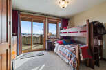 This cozy bedroom features a rustic bunk bed, perfect for accommodating guests or family.
