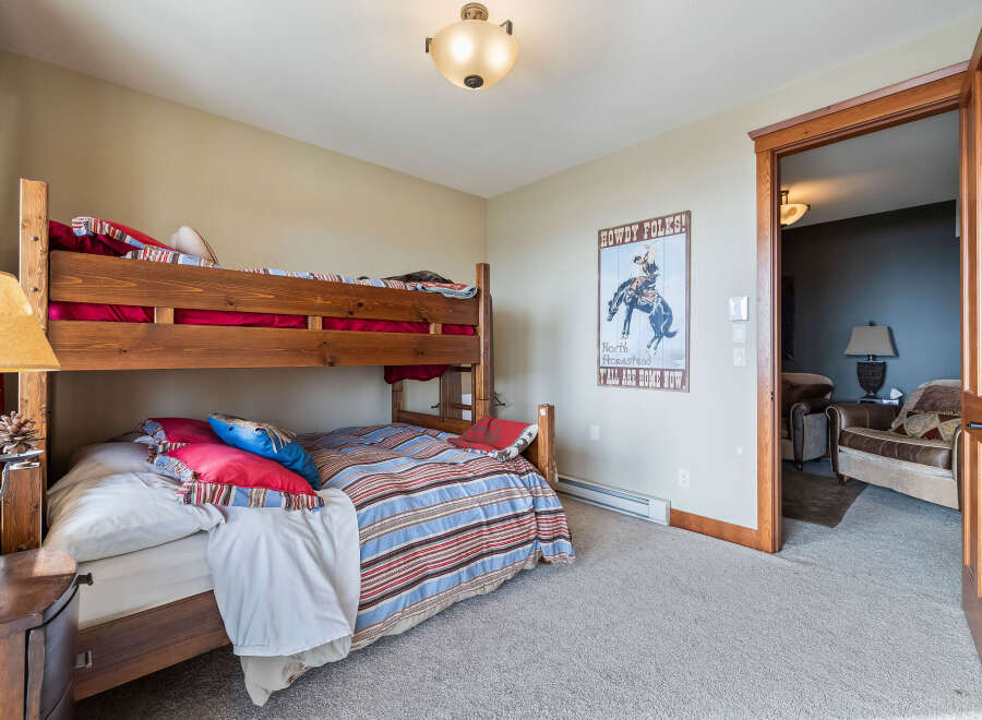 This charming bedroom features a cozy bunk bed, perfect for accommodating guests or family members.