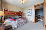 This charming bedroom features a cozy bunk bed, perfect for accommodating guests or family members.