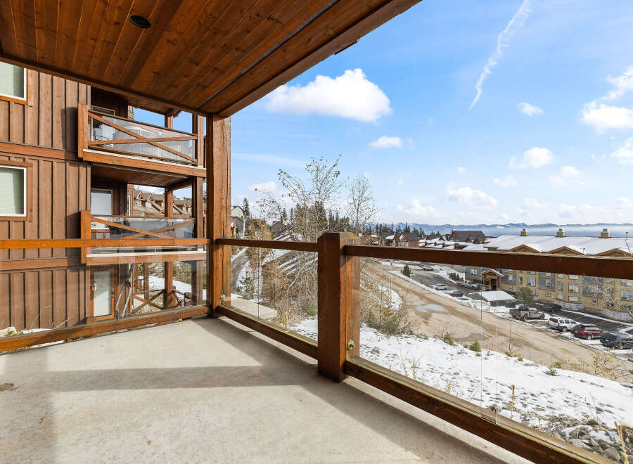 Enjoy breathtaking views from this stunning balcony overlooking a winter wonderland.