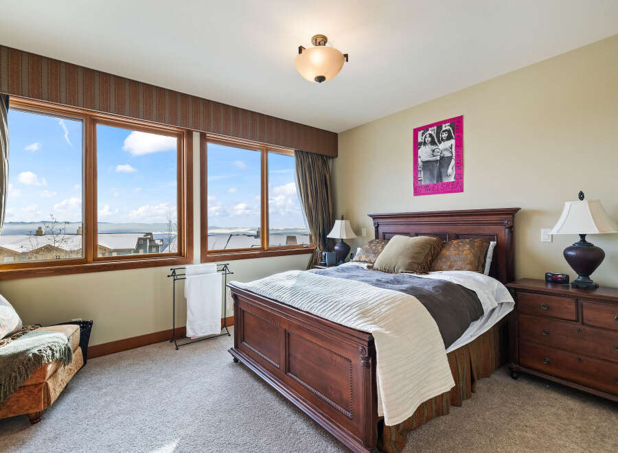 This stunning bedroom boasts a luxurious ambiance with its elegant wooden bed frame and plush bedding.