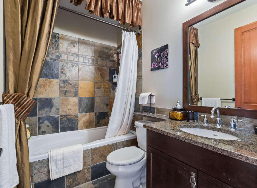 Step into this beautifully designed bathroom, featuring a stunning tile backsplash that adds a touch of elegance.