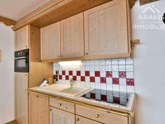This charming kitchen features beautiful wooden cabinetry and a stylish tiled backsplash.
