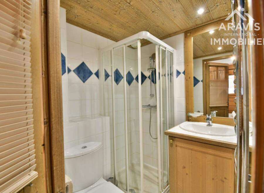 Discover this charming bathroom featuring a modern shower and a stylish vanity.