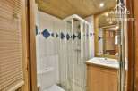 Discover this charming bathroom featuring a modern shower and a stylish vanity.