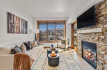 Experience luxury living in this stunning property, featuring a cozy fireplace and a modern TV setup.