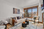 This stunning living room boasts a cozy ambiance with a comfortable sofa and stylish accent pillows.