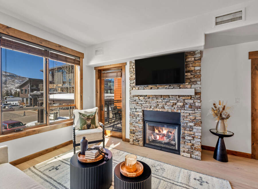 This stunning living space boasts a cozy fireplace, perfect for chilly evenings.