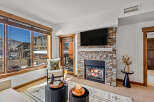 This stunning living space boasts a cozy fireplace, perfect for chilly evenings.