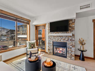 This stunning living space boasts a cozy fireplace, perfect for chilly evenings.