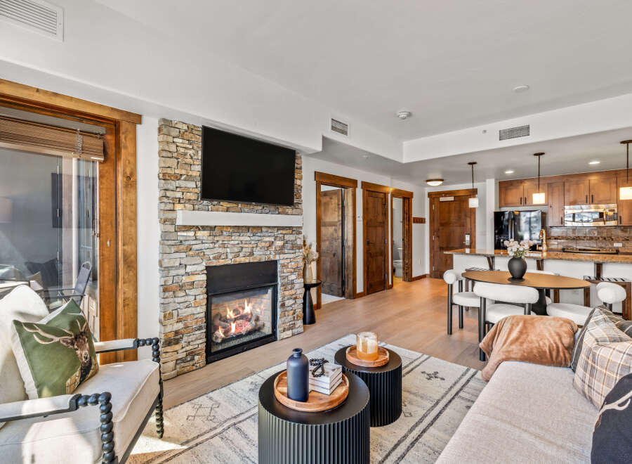Experience luxury living in this stunning property featuring a cozy fireplace and a modern kitchen.
