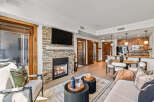 Experience luxury living in this stunning property featuring a cozy fireplace and a modern kitchen.