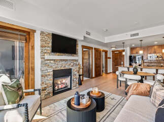 Experience luxury living in this stunning property featuring a cozy fireplace and a modern kitchen.