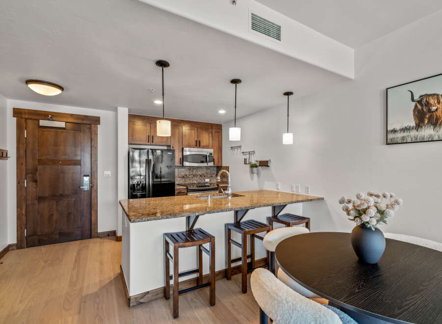 This stunning kitchen features a sleek design with modern appliances and ample counter space, perfect for culinary enthusiasts.