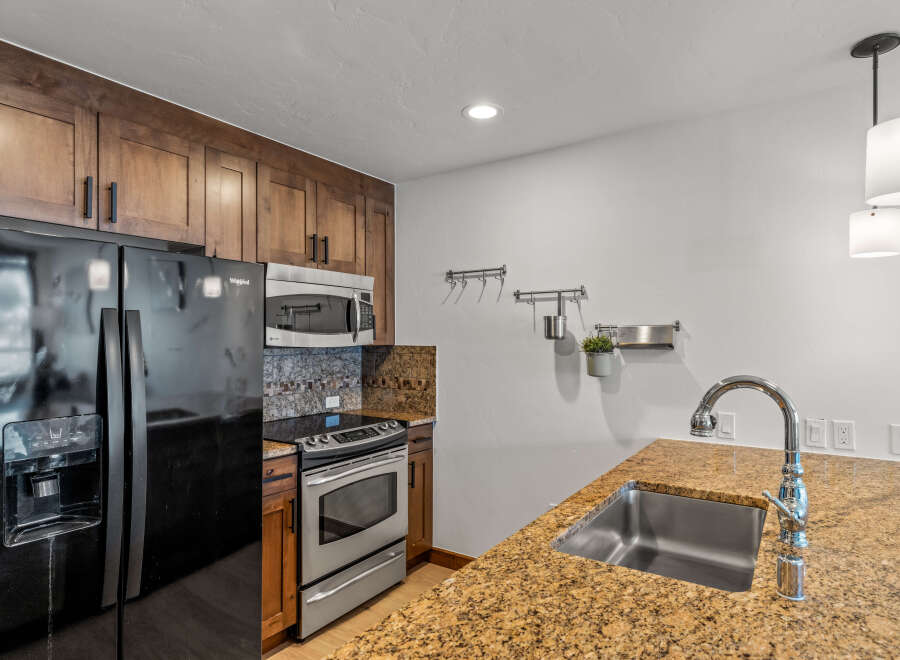 This stunning kitchen boasts a modern design with sleek stainless steel appliances and beautiful wooden cabinetry.