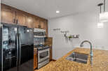 This stunning kitchen boasts a modern design with sleek stainless steel appliances and beautiful wooden cabinetry.