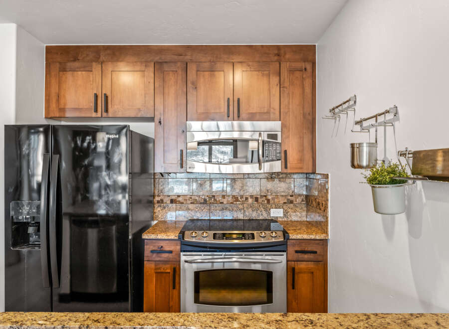 This stunning kitchen boasts beautiful wooden cabinetry, offering ample storage space.