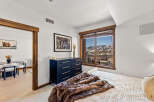 This stunning bedroom boasts a luxurious ambiance with its plush fur throw and elegant dark wood dresser.