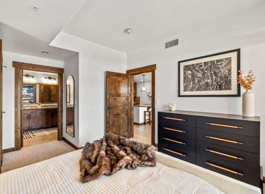 Step into luxury with this stunning bedroom, featuring a plush bed and a stylish dresser.