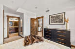 Step into luxury with this stunning bedroom, featuring a plush bed and a stylish dresser.