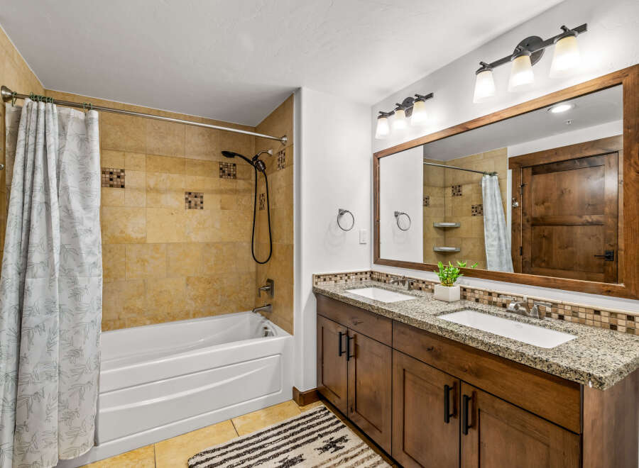 This stunning bathroom features a luxurious design with a beautiful vanity and a spacious bathtub.