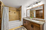 This stunning bathroom features a luxurious design with a beautiful vanity and a spacious bathtub.