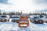 Explore the winter wonderland at Big White Ski Resort! This stunning property offers a unique experience with its charming wooden chair and ample parking.